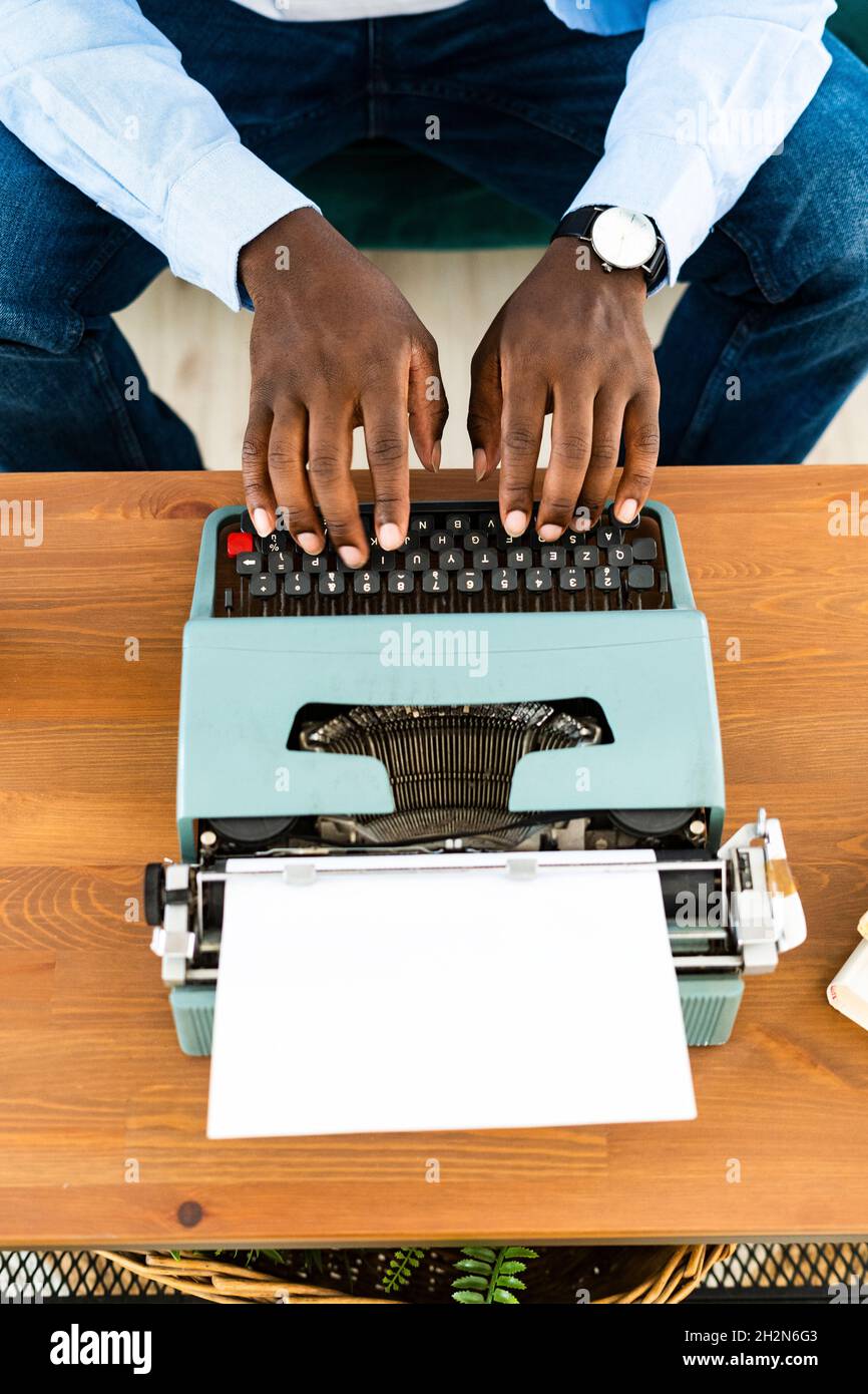 Homme utilisant la machine à écrire à la maison Banque D'Images