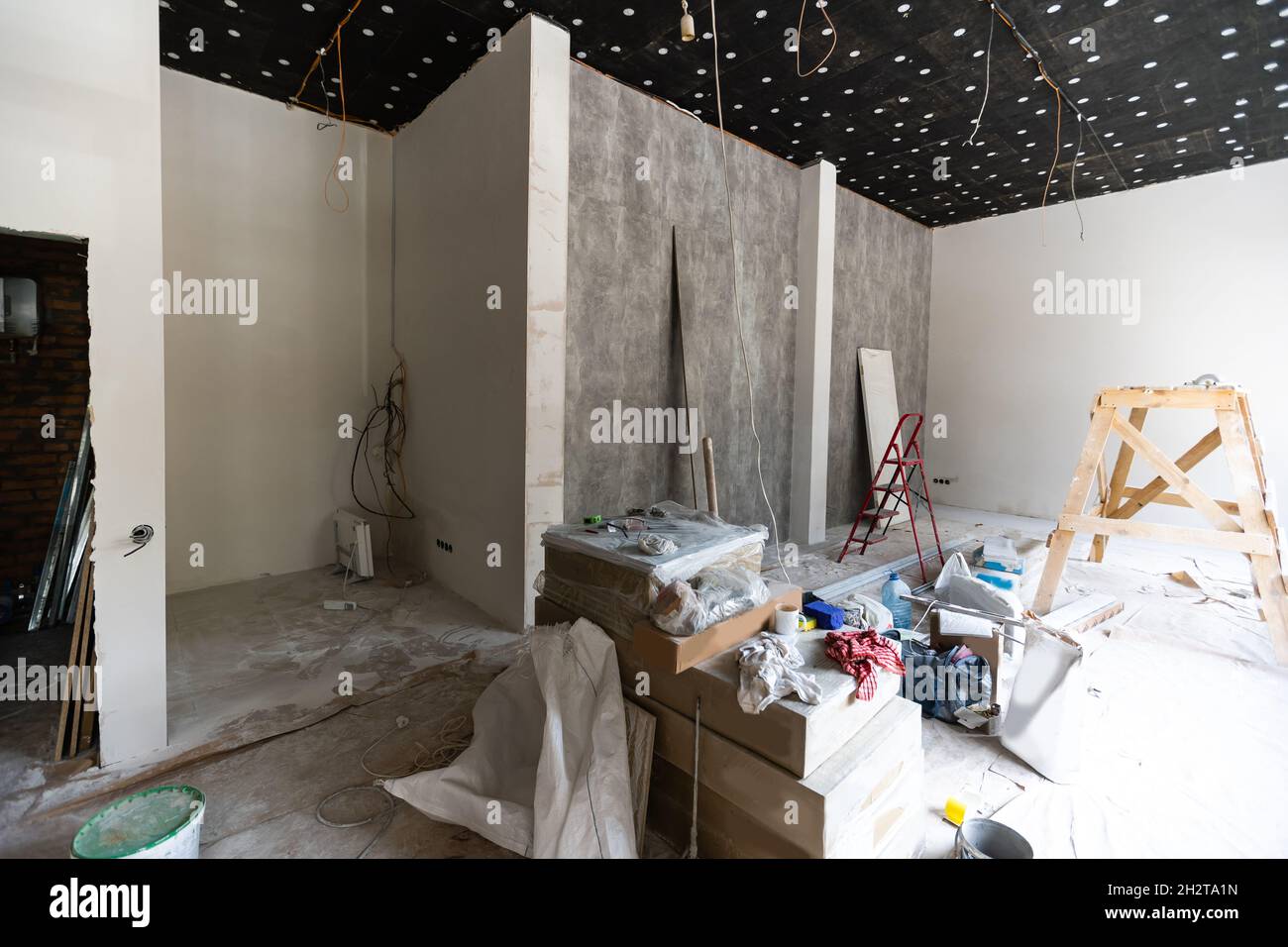 Les travailleurs installent des plaques de plâtre pour les murs de gypse dans l'appartement est en construction, remodelage, rénovation, extension, restauration et Banque D'Images