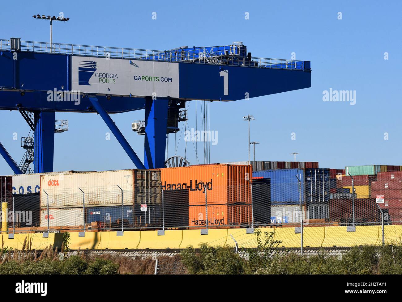 Savannah, États-Unis.23 octobre 2021.Les conteneurs d'expédition sont vus sous une grue au port de Savannah en Géorgie.La crise de la chaîne d'approvisionnement a créé un arriéré de près de 80,000 conteneurs d'expédition dans ce port, le troisième plus grand port à conteneurs des États-Unis, avec environ 20 navires ancrés au large de la côte atlantique, attendant de décharger leur cargaison.Une pénurie de chauffeurs routiers pour transporter des marchandises des entrepôts aux détaillants a entraîné l'acheminement des conteneurs d'expédition au port.Crédit : SOPA Images Limited/Alamy Live News Banque D'Images