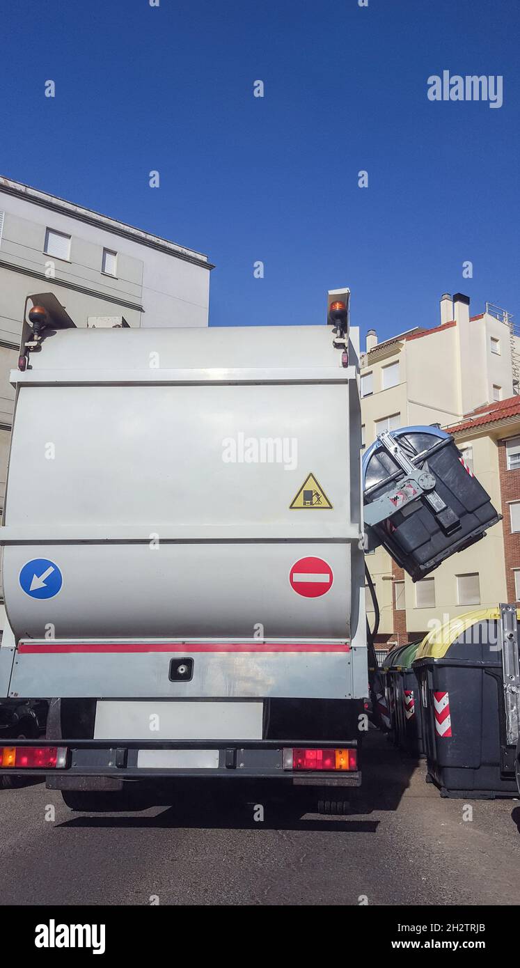 Camion à ordures collectant la benne à papier urbaine.Le circuit hydraulique intelligent monte automatiquement le réservoir bleu du côté Banque D'Images