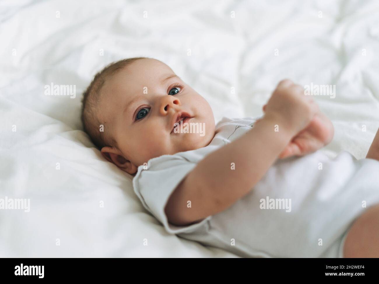 Mignon Bebe Fille 2 4 Mois Sur Le Lit Avec Linge Blanc Tons Naturels Selectif Foyer Photo Stock Alamy