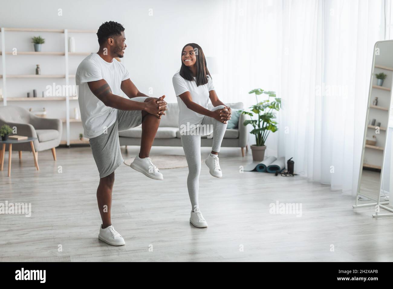 Jeune couple noir faisant un exercice de genou élevé Banque D'Images