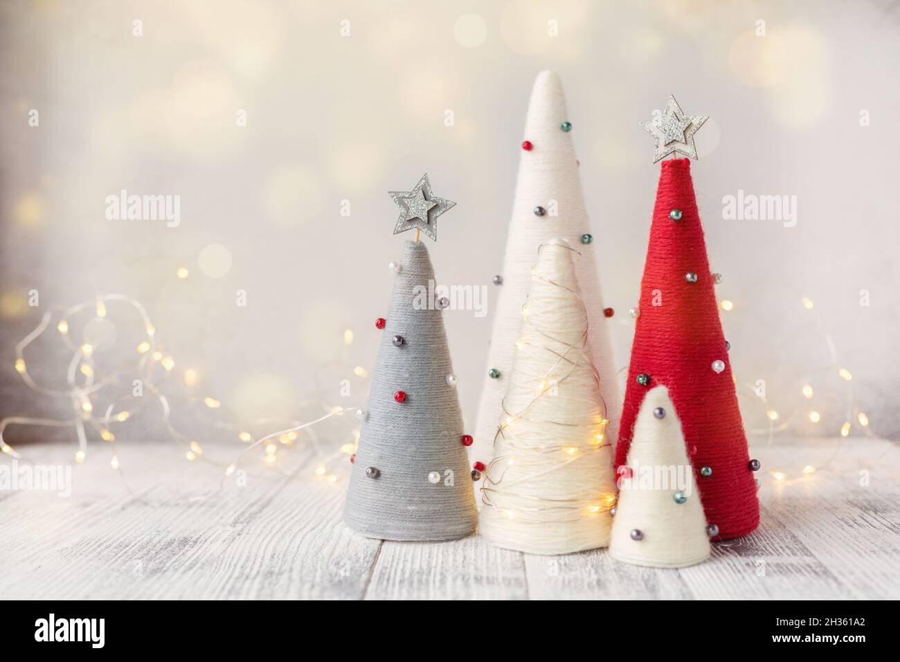 Arbres de Noël faits main.Arbres coniques et guirlande enveloppés de fils.Décorations artisanales pour décorer votre maison pendant les vacances - image Banque D'Images