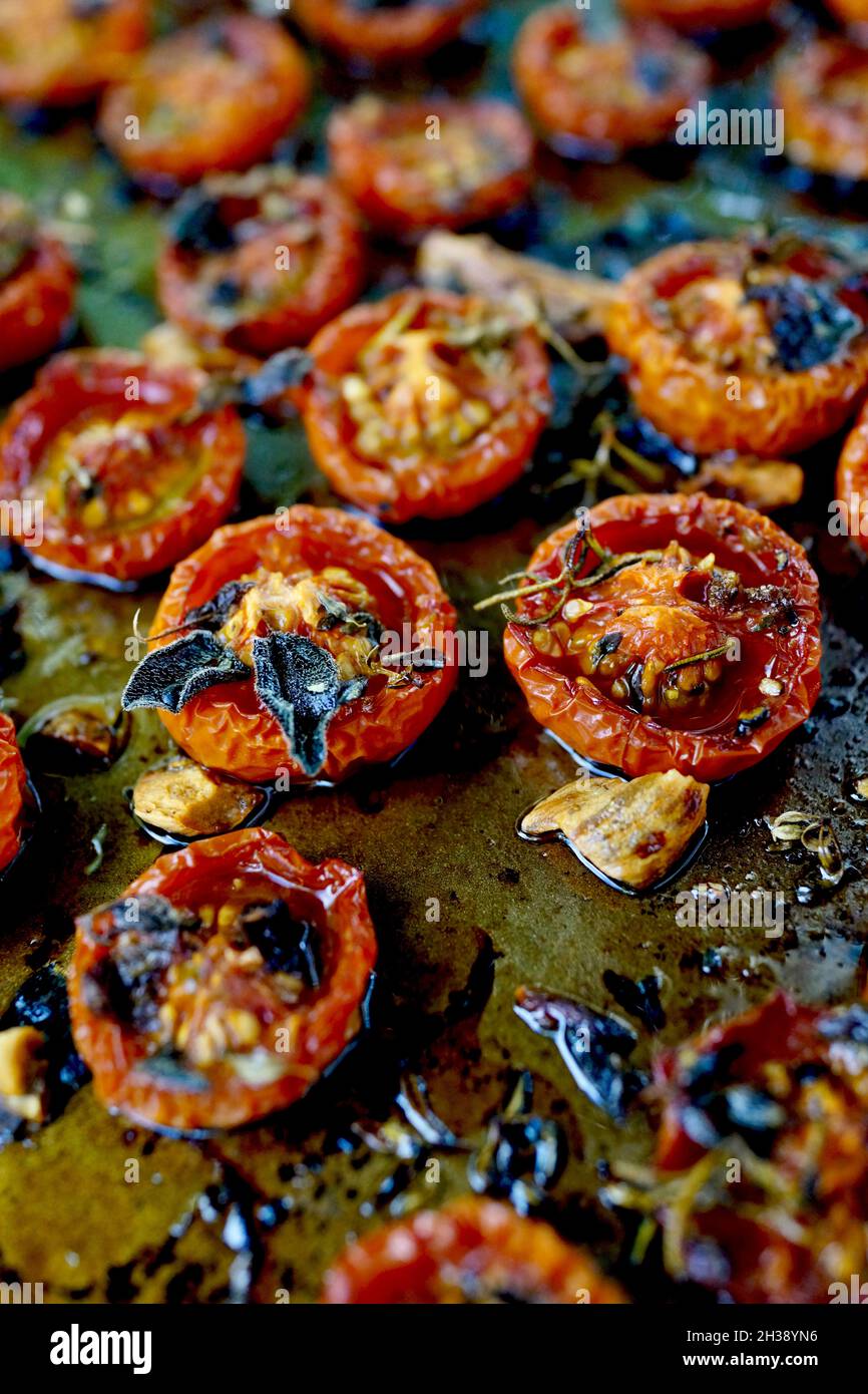 Tomates cerises grillées sur une casserole plate.Saupoudrée d'huile d'olive  et de thym, de sel de mer et de poivre Photo Stock - Alamy