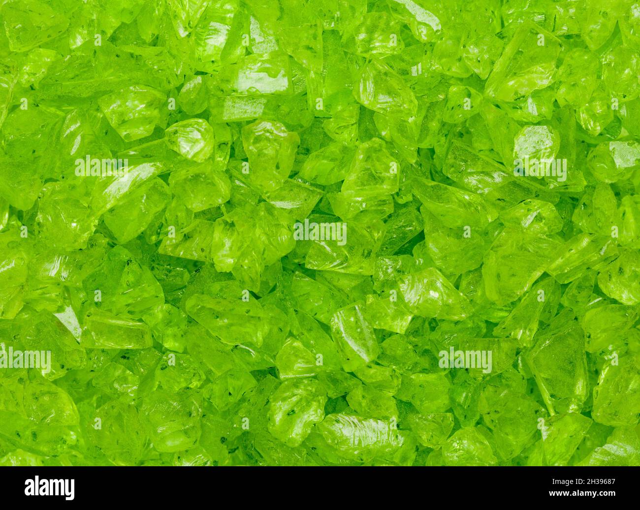 Morceaux de verre cassés verts dans un arrière-plan de pile. Banque D'Images