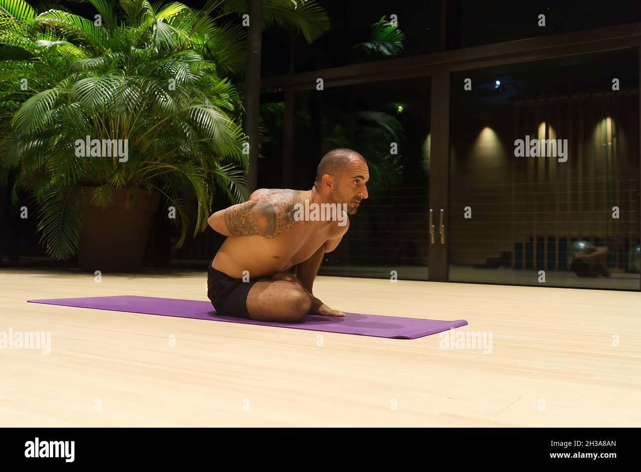 Omar Mura homme caucasien d'âge moyen exécute une position de yoga à l'intérieur. Banque D'Images