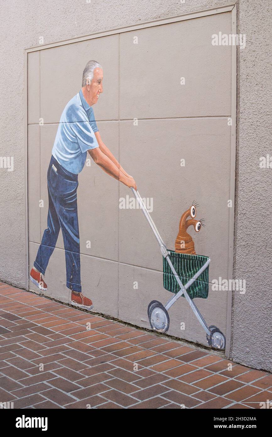 Homme poussant le chat à poussette, 1975 murale par Greg Brown - mis à jour dans les années 1980 pour présenter Spiro Agnew poussant un alien dans une poussette. Banque D'Images