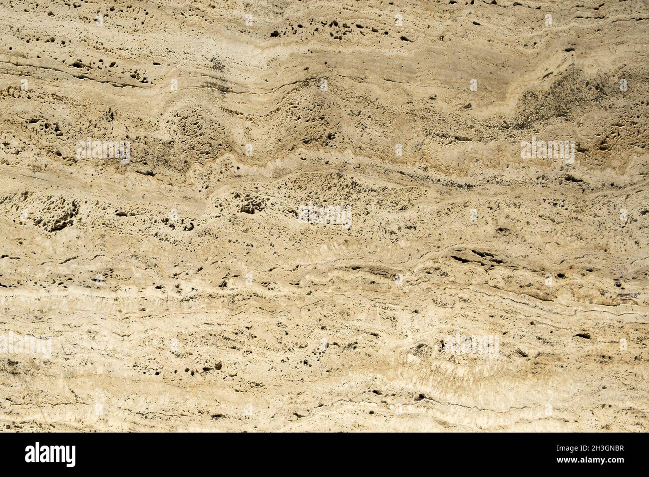 Gros plan d'un carreau de pierre naturelle en béton abstrait sur le mur.Mur vieilli avec arrière-plan texturé Banque D'Images