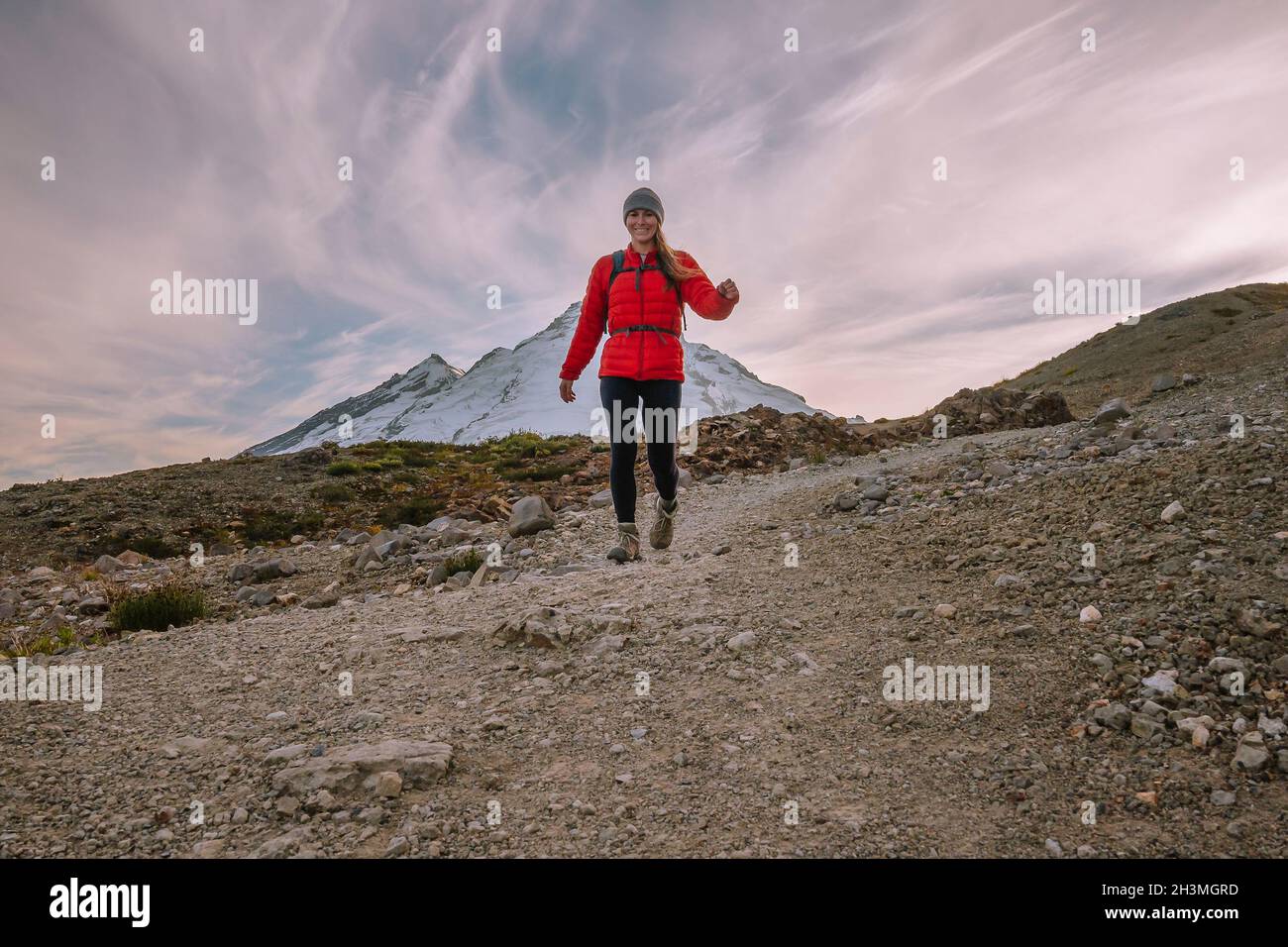 Femme en collant et manteau de bouffy rouge randonnée dans les Cascades du Nord Banque D'Images
