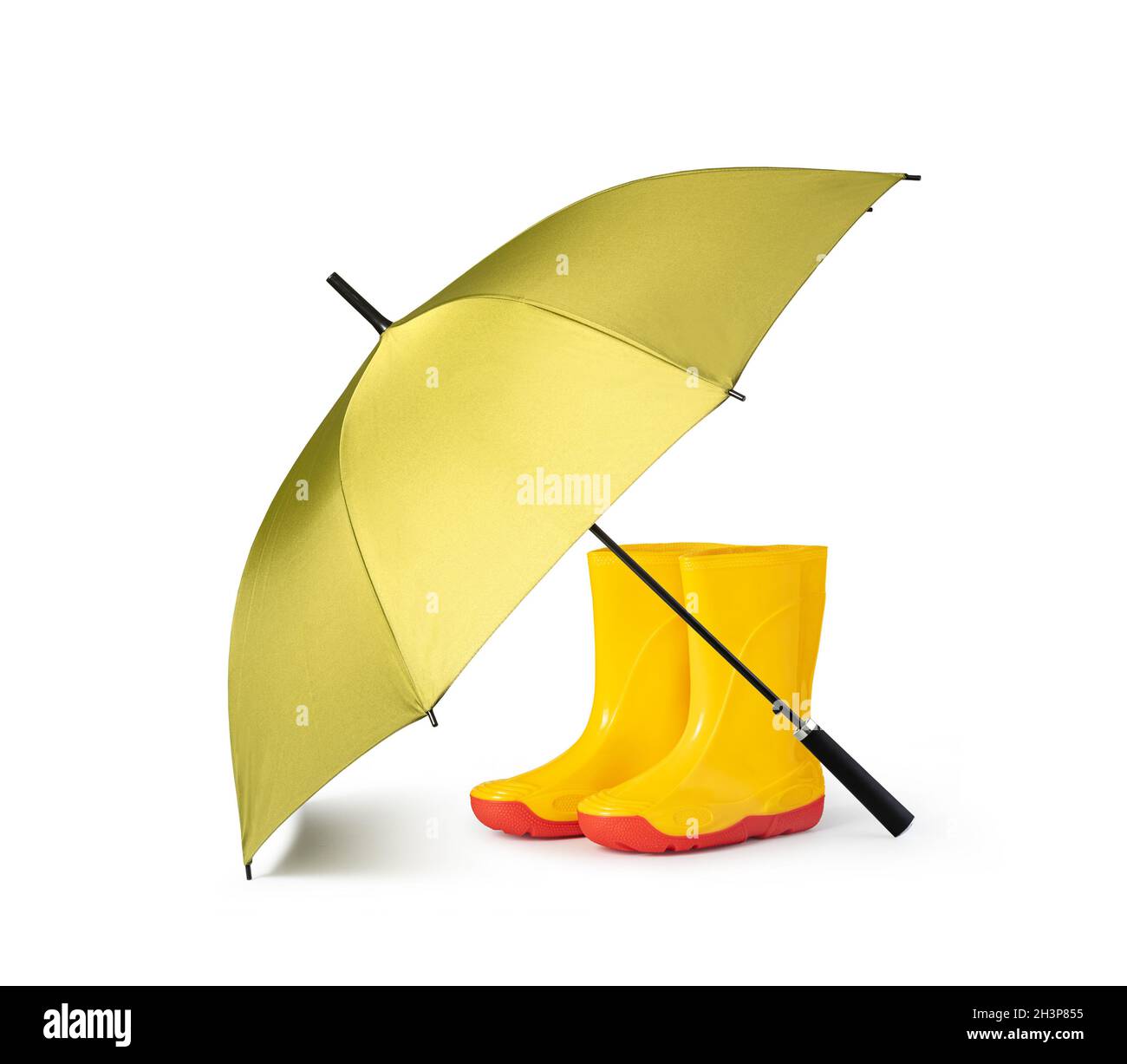 Parapluie vert et bottes de gommer Banque D'Images