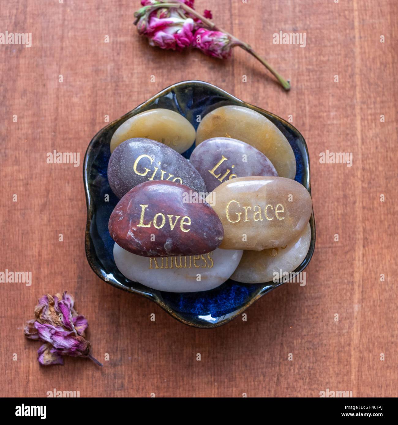 Pierres motivationnelles inspirantes avec des écrits.Sérénité, gratitude, passion, amour sur fond de table rouge Banque D'Images