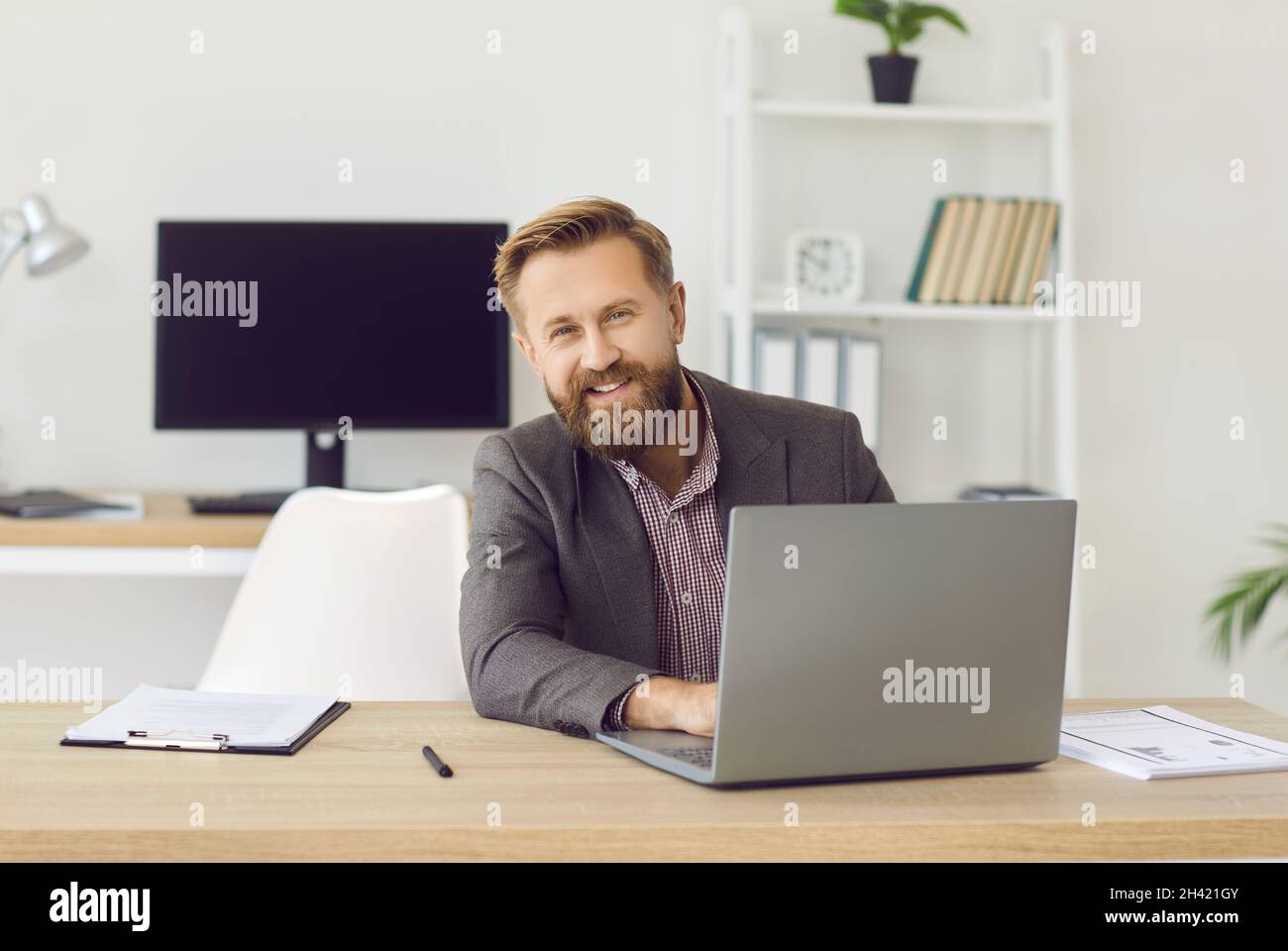 Portrait d'un homme d'affaires souriant sur un ordinateur portable en ligne Banque D'Images