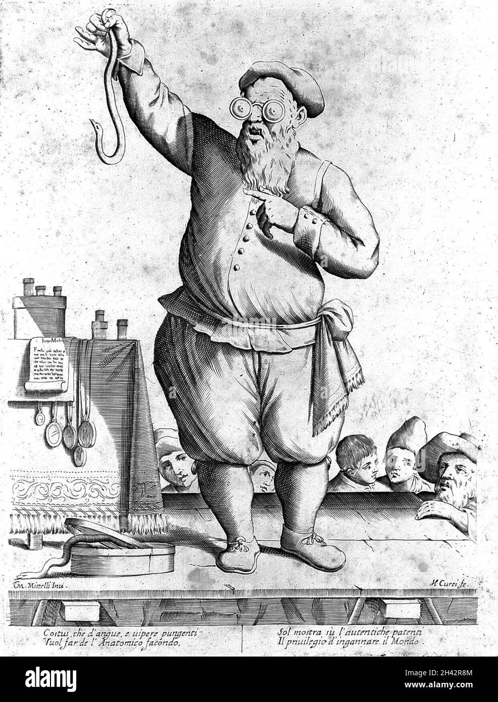 Un charlatan portant des lunettes et tenant un serpent, Bologne. Banque D'Images