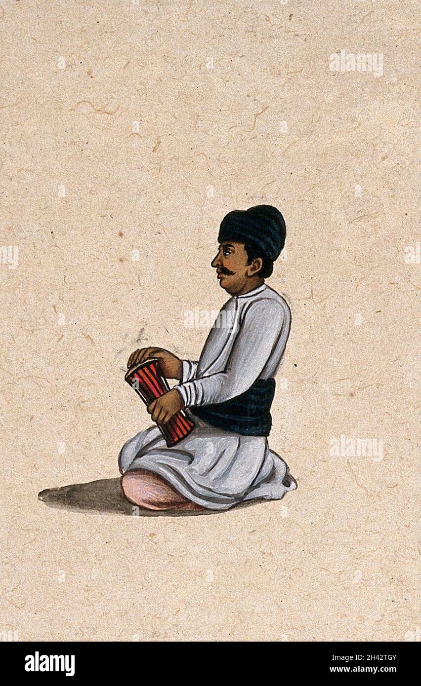 Un musicien tenant un instrument de percussion indien.Peinture de gouache par un artiste indien. Banque D'Images