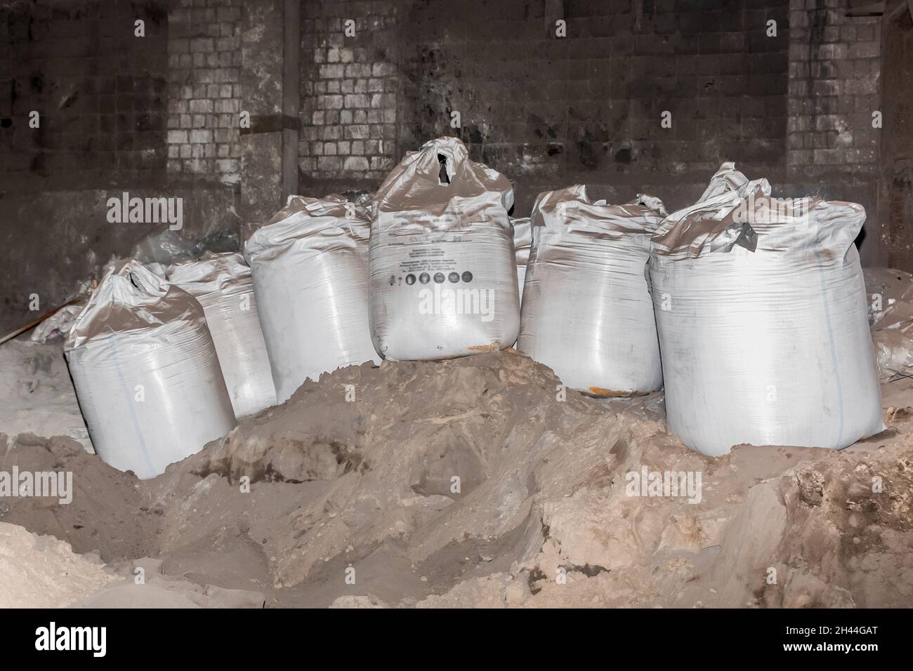 Poudre d'argile bentonite emballée dans des sacs dans une usine industrielle pour le traitement du sable, du sol et du sol. Banque D'Images