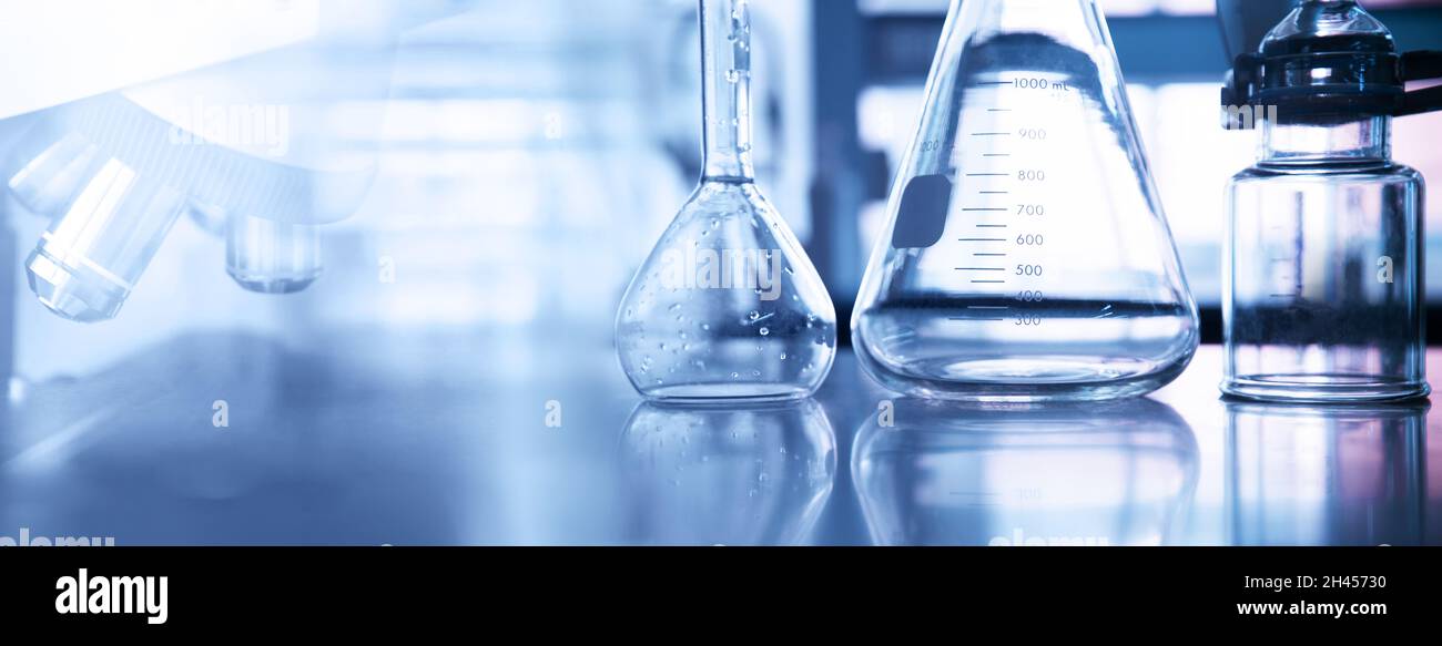 fiole conique et volumétrique en verre avec microscope et équipement scientifique en laboratoire de chimie fond de bannière bleu violet Banque D'Images