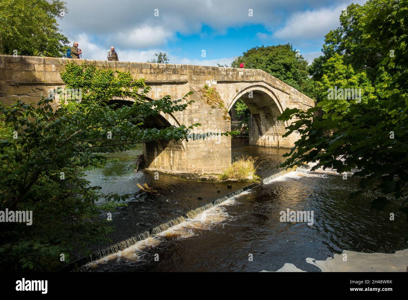 Vue sur le pont à cheval à Ilkley avec les personnes qui s'y promeunent, West Yorkshire, Royaume-Uni Banque D'Images