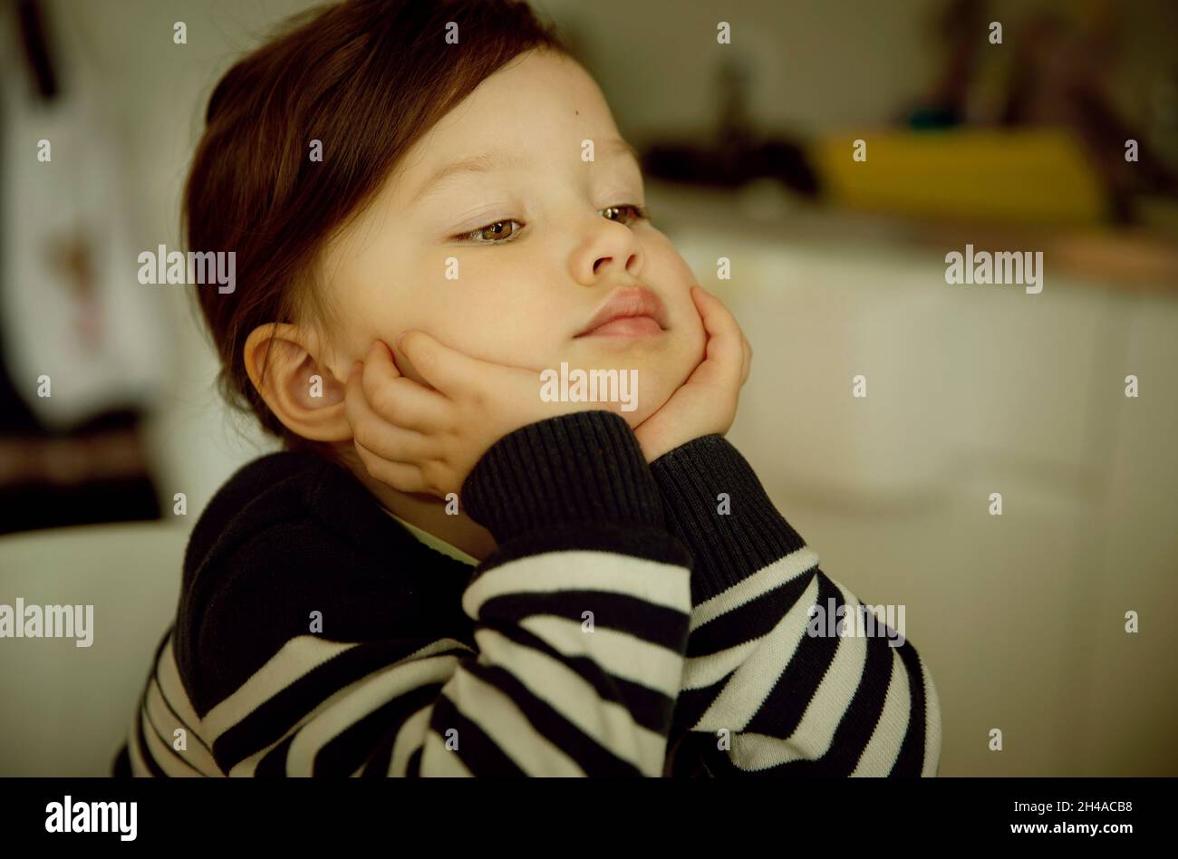 Petite fille ennuyeuse regardant la télévision Banque D'Images