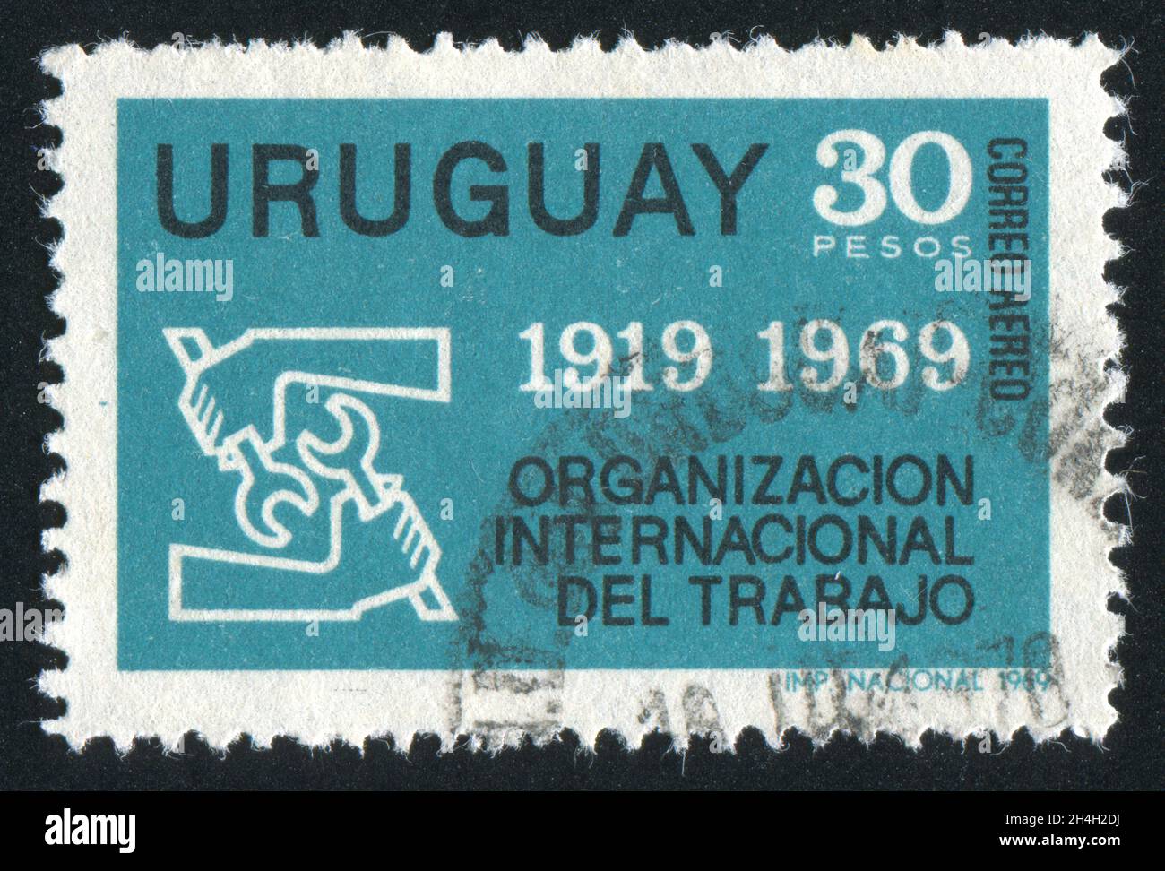 URUGUAY - VERS 1969: Timbre imprimé par l'Uruguay, montre l'emblème de l'Organisation internationale du travail, vers 1969 Banque D'Images