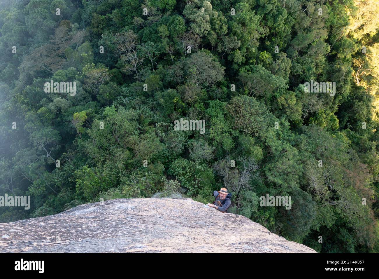 Brésil, Rio de Janeiro, escalade sur le pain de sucre, chemin italien, Erwan Lelann dans la dalle surplombant la forêt Banque D'Images