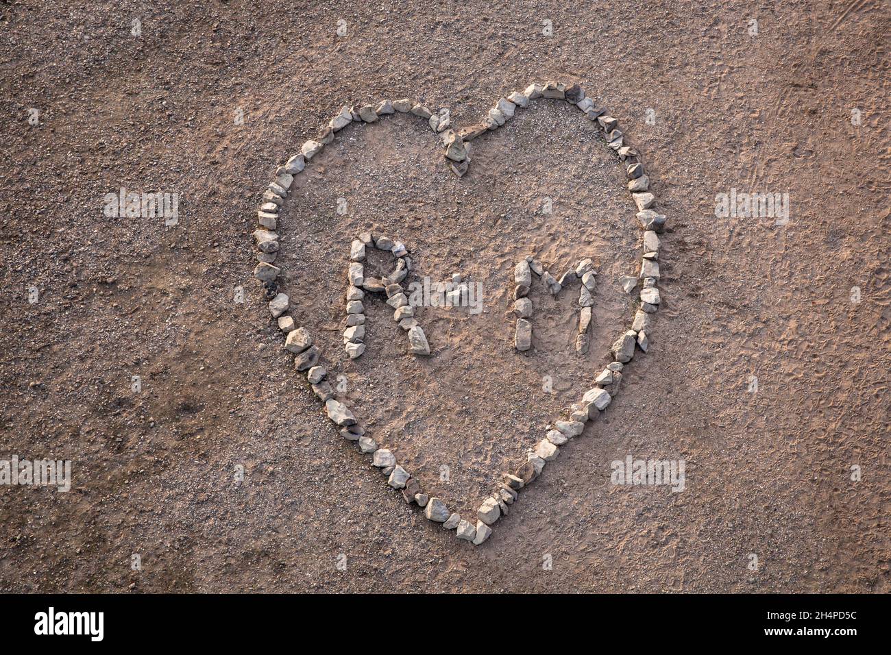 Un grand coeur ( environ 4 x 5 mètres ) fait de pierres de basalte du renforcement de la rive du Rhin dans le district de Poll, Cologne, Allemagne. ei Banque D'Images