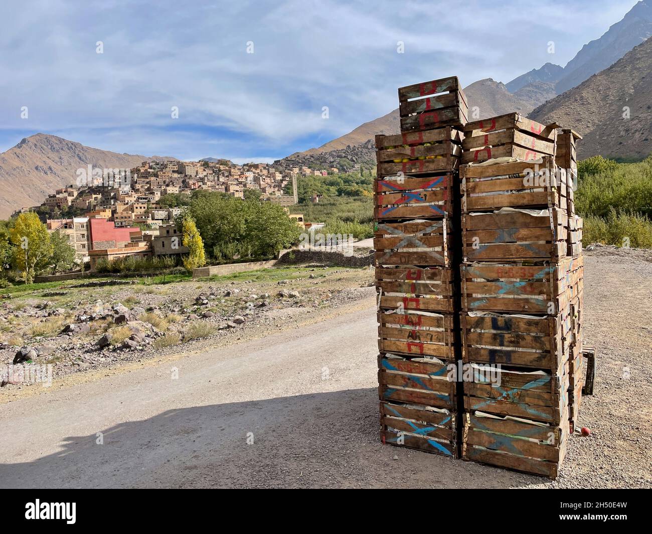 Caisses Apple avec Imlil en arrière-plan.Montagnes du Haut Atlas, Maroc. Banque D'Images