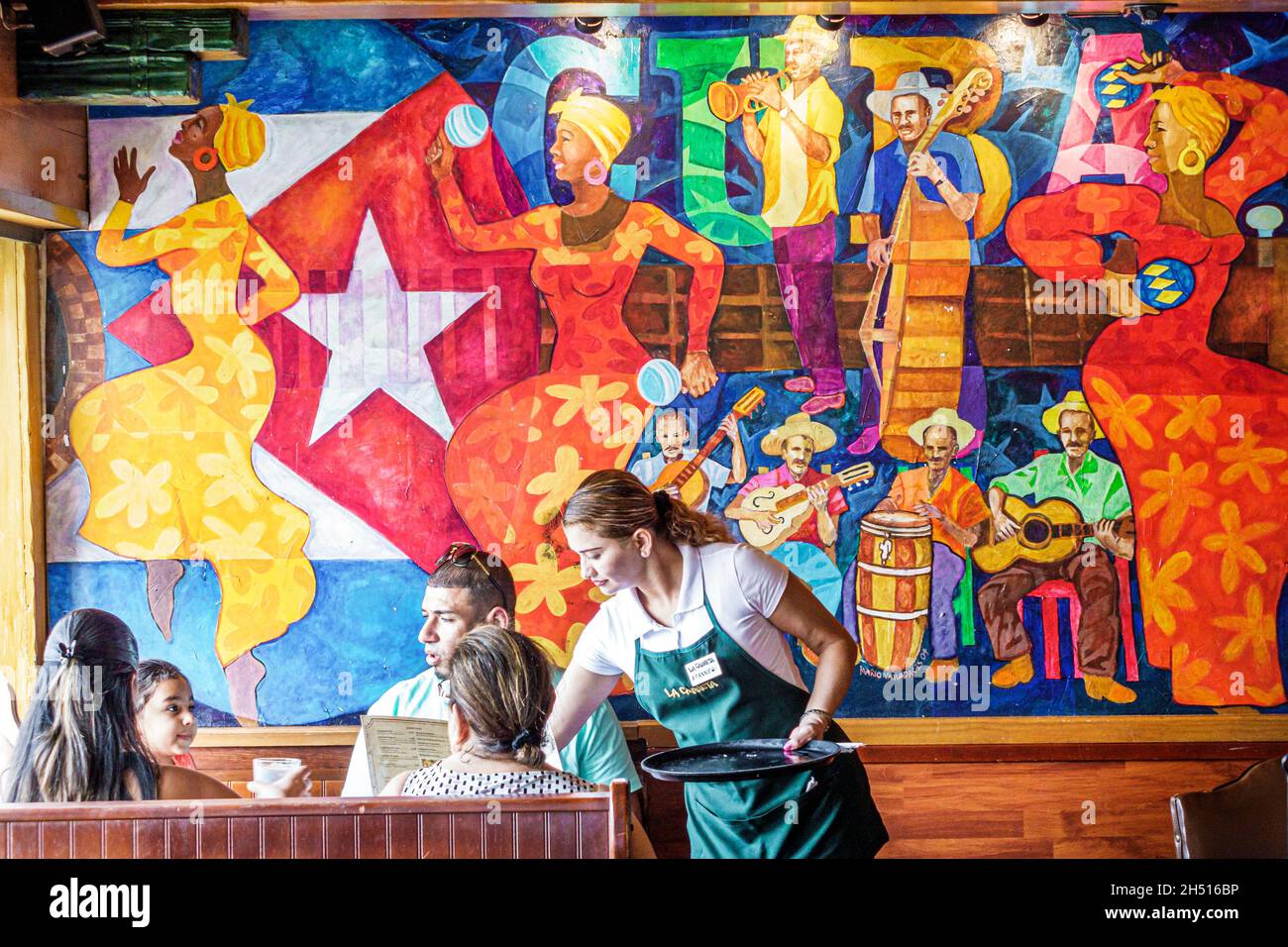 Miami Florida, Little Havana, Calle Ocho, la Carreta restaurant cuisine cubaine, intérieur, art mural, serveur hispanique servant table stand famille Banque D'Images