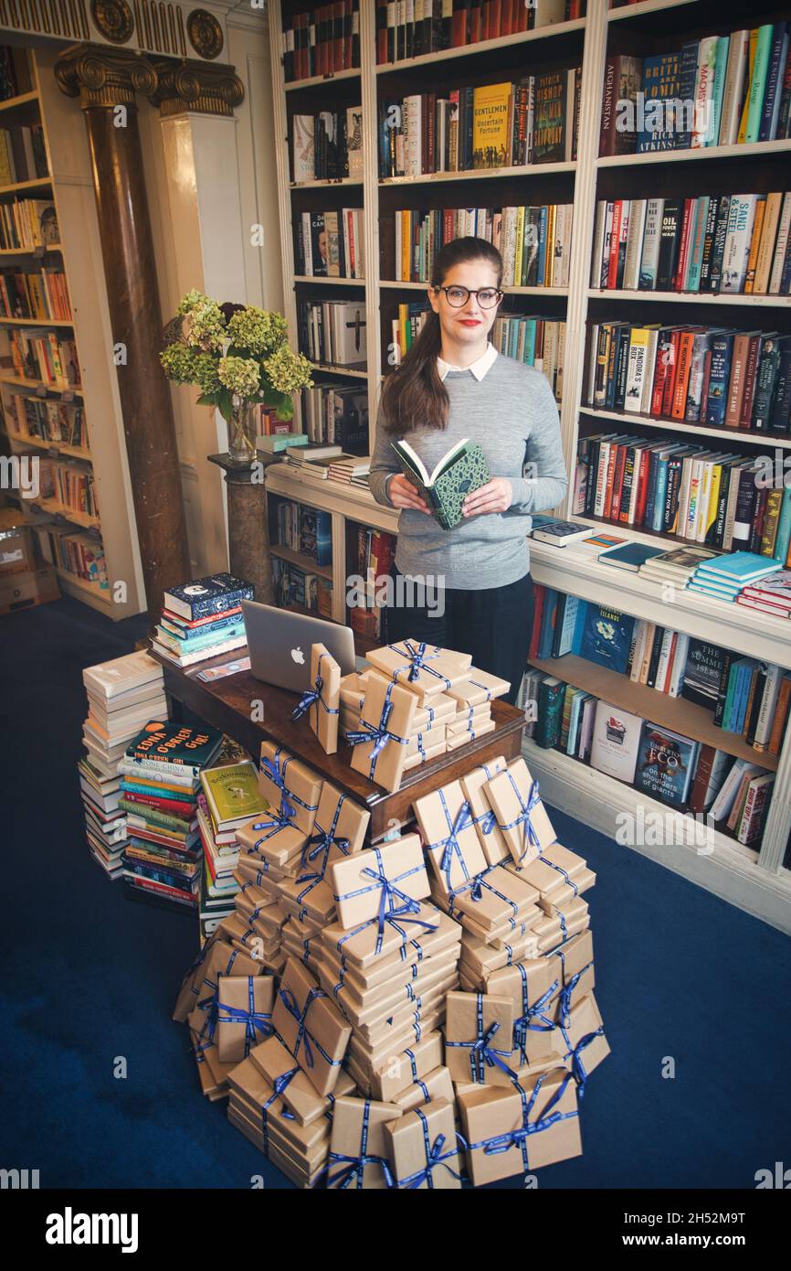 GRAND BRITAN / Londres / librairies / belle femme lisant un livre dans une librairie. Banque D'Images
