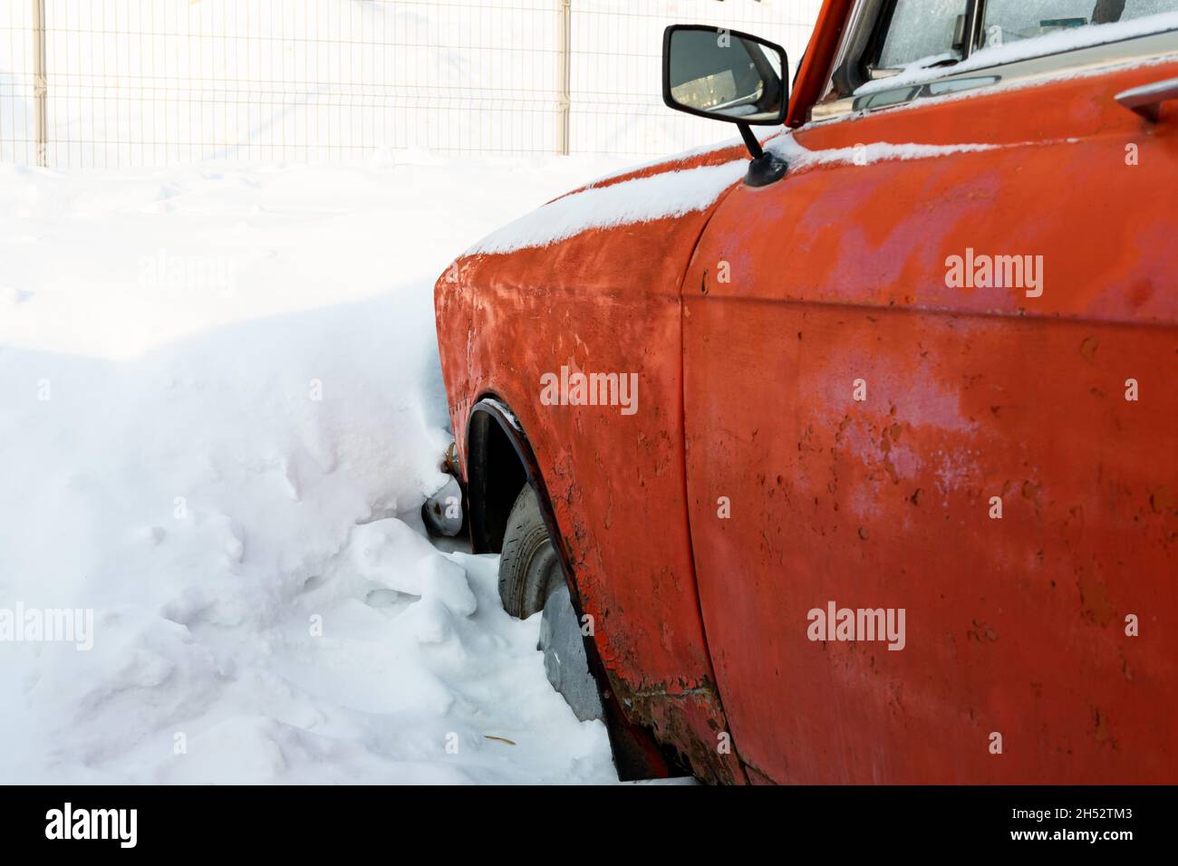 vieille voiture rétro brisée rouge rouillé vieux garé en hiver sur fond de neige le jour d'hiver glacial Banque D'Images