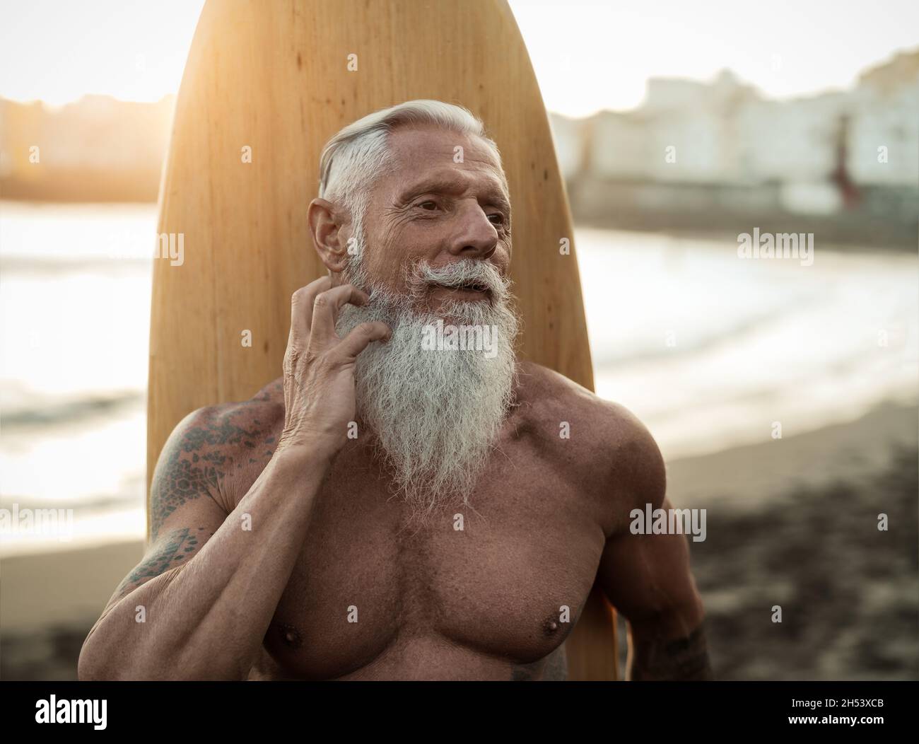 FIT senior homme ayant le plaisir pratiquer le surf sur la plage tropicale - personnes âgées saines mode de vie et sport extrême concept Banque D'Images