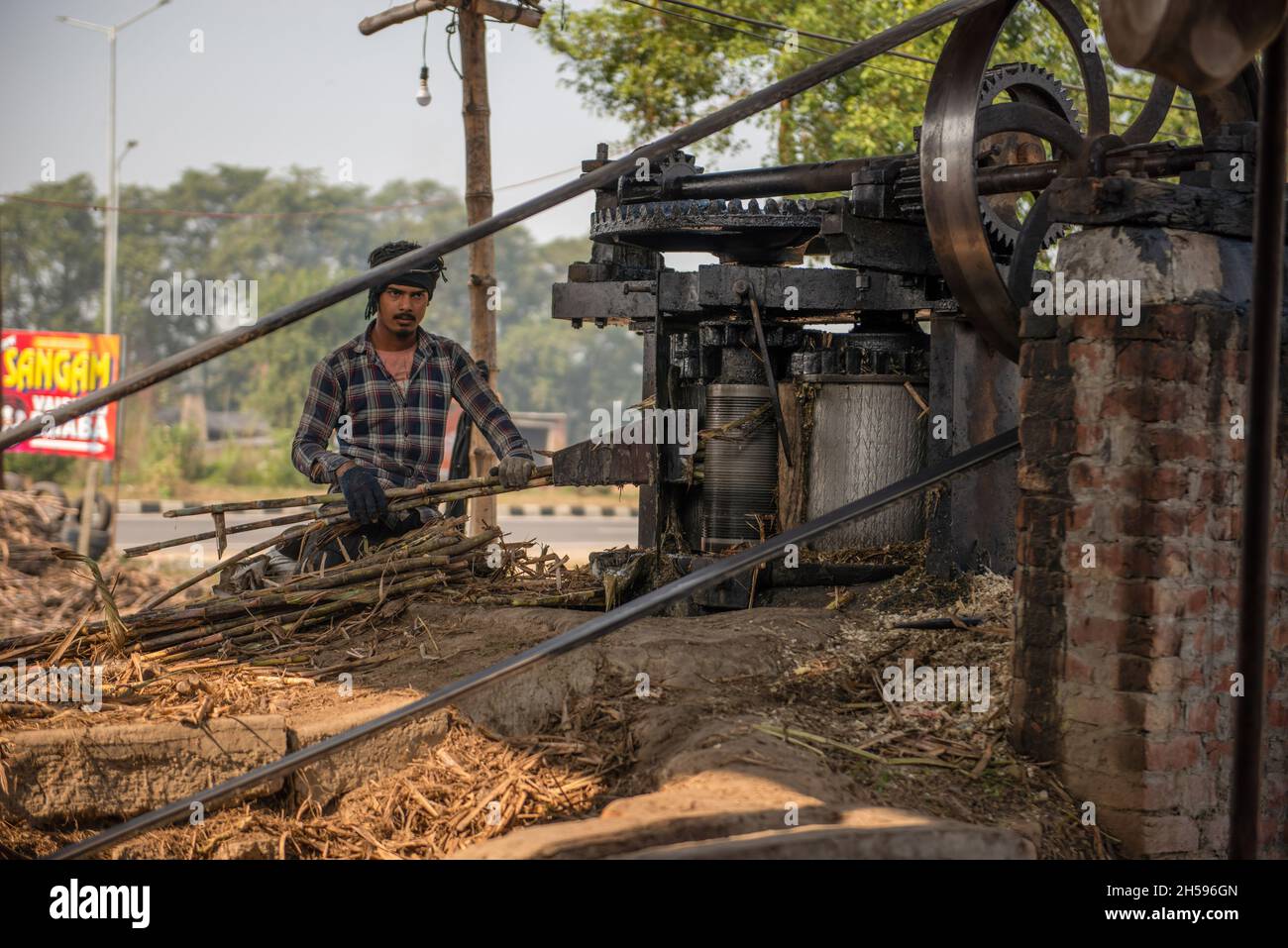 Roorkee, Inde.07th nov. 2021.Un jeune travailleur place la canne à sucre dans un broyeur pour extraire du jus pendant la production de jaggery dans une unité de production de Jaggery dans la partie inférieure de Roorkee.la fabrication de jaggery à partir de jus de canne à sucre est une industrie rurale traditionnelle dans de nombreuses régions de l'Inde.Plus de 70% de la production mondiale totale de jageries est réalisée par l'Inde.(Photo de Pradeep Gaur/SOPA Images/Sipa USA) crédit: SIPA USA/Alay Live News Banque D'Images