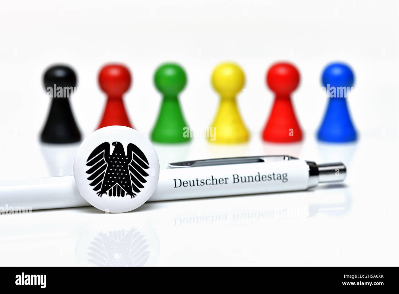 Spielfiguren in den Farben der größten deutschen Parteien und Kugelschreiber des Deutschen Bundesadler, Symbolfoto Bundesagswahl und Banque D'Images