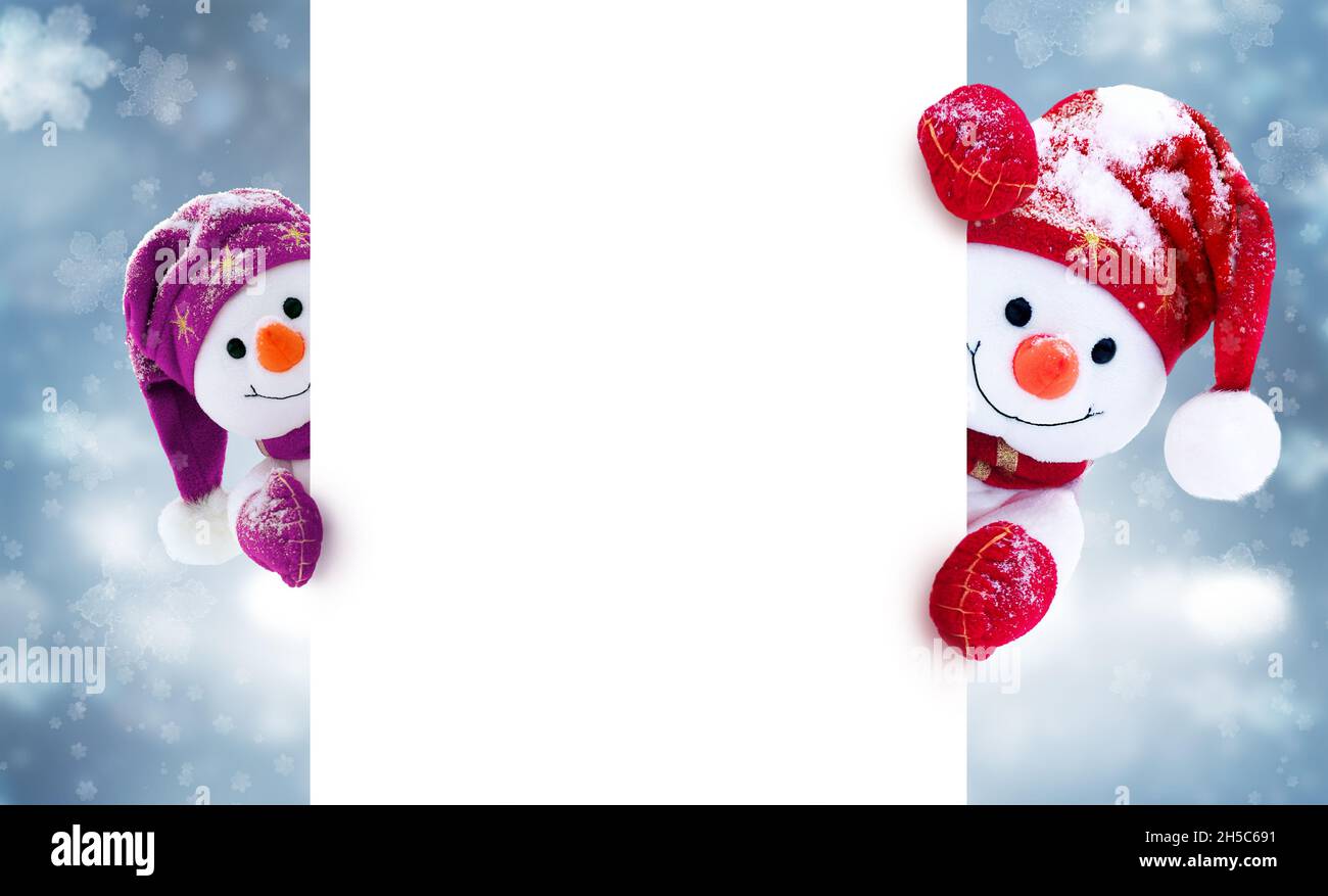 Petits bonhommes de neige en casquettes et en foulards sur fond d'hiver.Décor festif avec des bonhommes de neige amusants.Carte de Noël, espace de copie. Banque D'Images