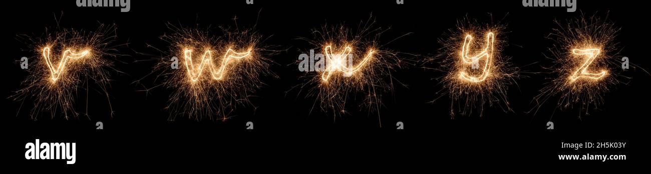 golden Bright sparkler alphabet police lettre ensemble collection partie V à Z isolé sur fond noir foncé. silvester nouvel an anniversaire et célébration Banque D'Images
