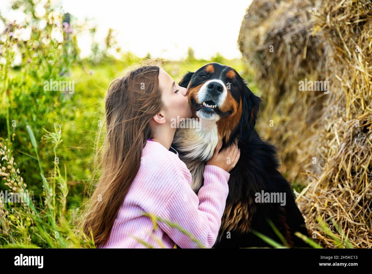 Jeune fille avec son chien dans une ferme; Alcomdale, Alberta, Canada Banque D'Images