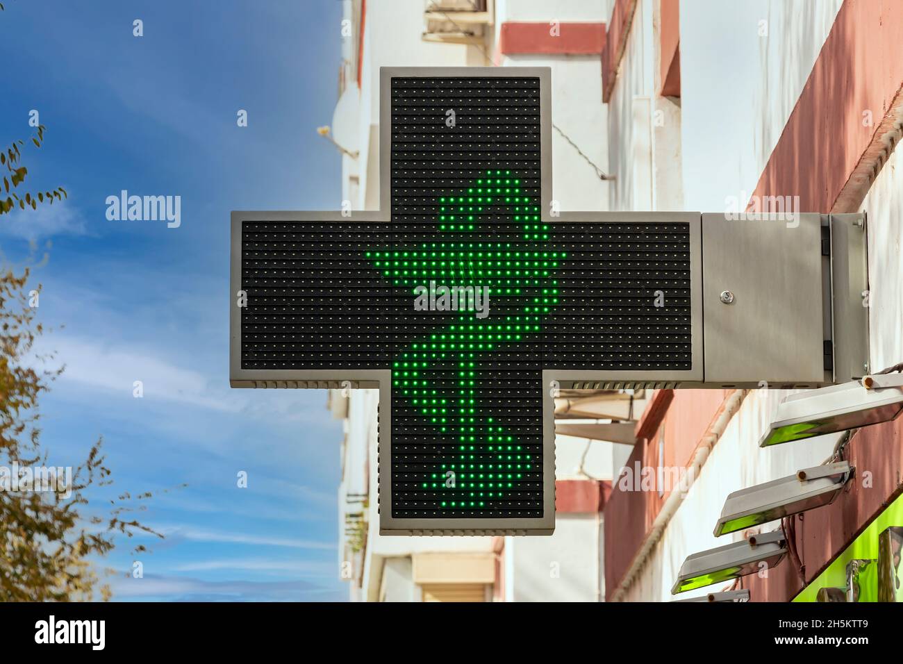 Croix verte de pharmacie électronique avec le symbole du serpent dans