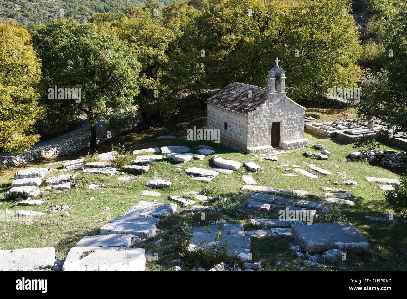 Vue sur la nécropole de Stećak SV.Barbara (Dubravka, Konavle, Dubrovnik-Neretva, Croatie) avec stecci et chapelle Banque D'Images