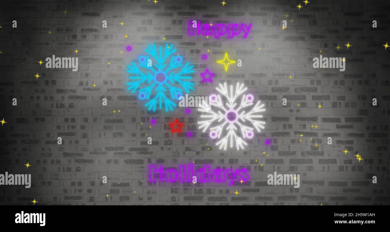 Image du texte de Noël au néon sur des flocons de neige Banque D'Images