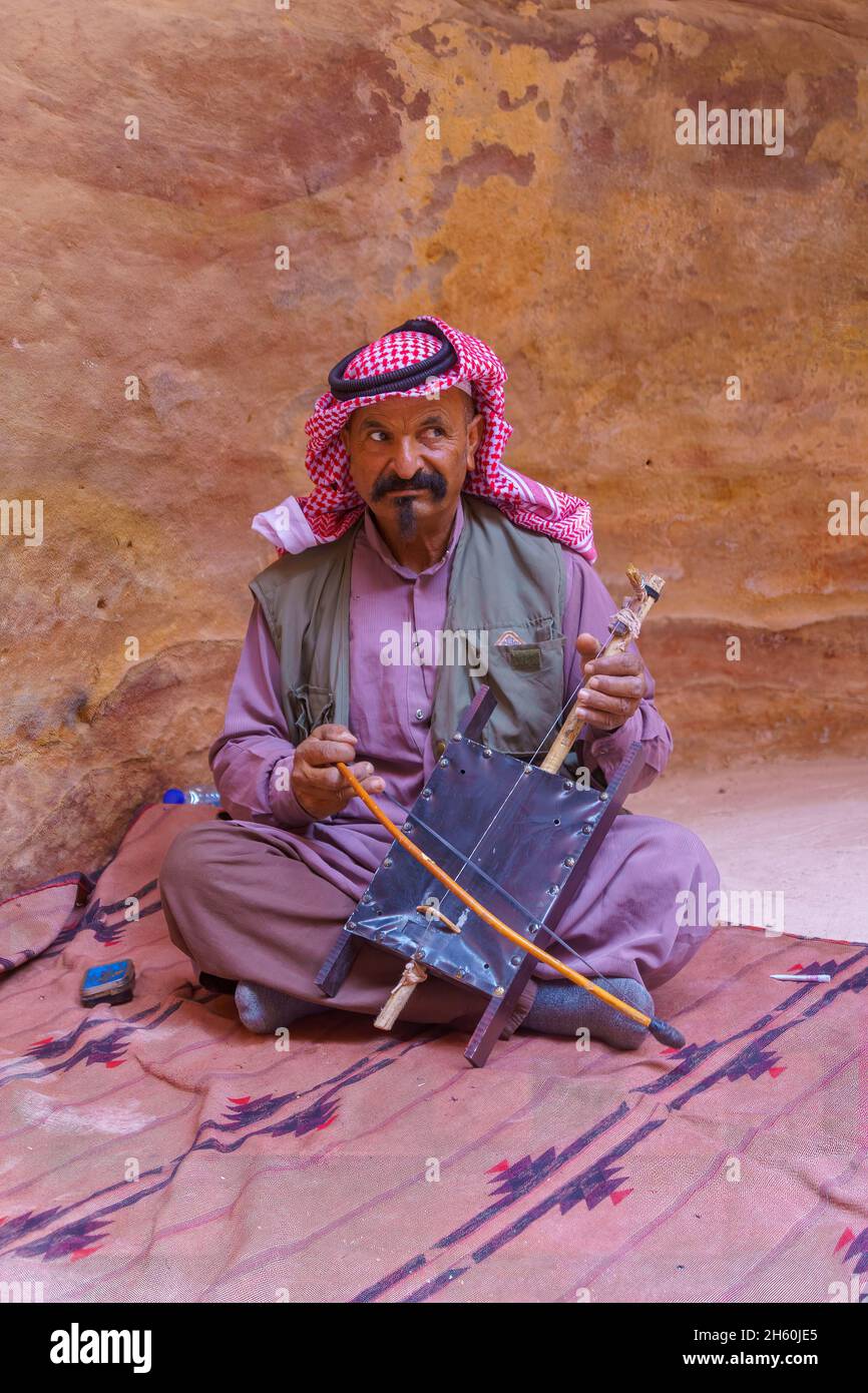 Petra, Jordanie - 23 octobre 2021: Portrait d'un homme bédouin local joue un Rebab, dans l'ancienne ville nabatéenne de Petra, au sud de la Jordanie Banque D'Images