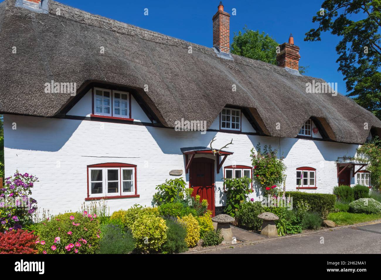 angleterre,hampshire,vallée test,wherwell,thatched cottages au printemps Banque D'Images