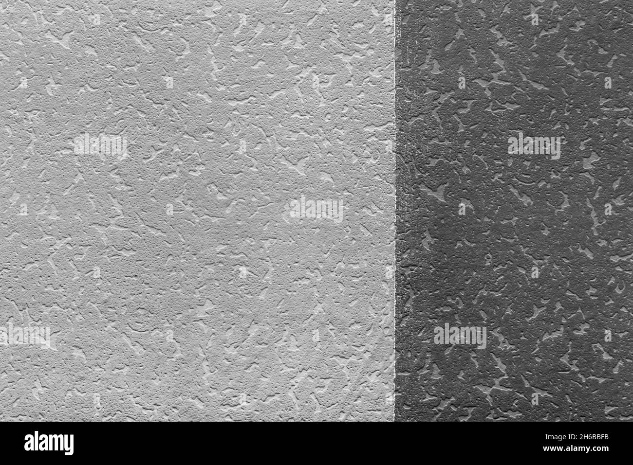 La surface de deux nuances de gris et de noir.Vide pour la conception.Fond d'écran sombre avec texture de mur à motif abstrait. Banque D'Images