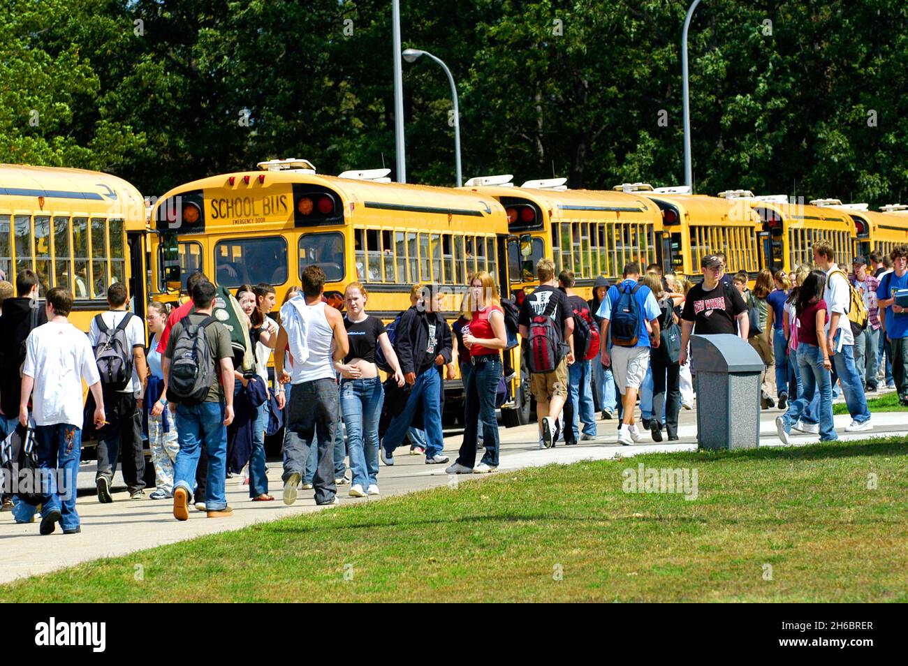 Les élèves du secondaire à la fin de la journée de trajet de transport d'autobus scolaires accueil Banque D'Images