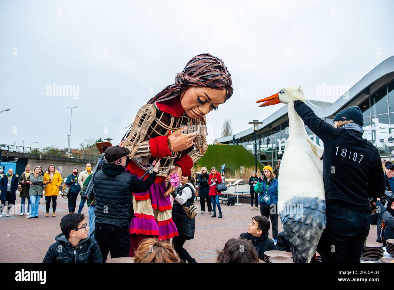 On voit un petit storage de marionnettes interagir avec Little Amal.Amar, un nouveau centre culturel au centre de la Haye, qui a organisé dans le cadre de son « Open Festival », la visite de la marionnette géante « Little Amal », une jeune fille réfugiée syrienne de neuf ans et de plus de 11 mètres de haut au parc miniature, Madurodam.Elle est invitée à participer au Festival en tant qu'invitée spéciale dans la ville pour attirer l'attention à travers l'Europe sur le sort des jeunes réfugiés qui ont fui la Syrie.Amal a été reçu à l'extérieur du parc par un groupe d'enfants, après qu'elle a pu se promener autour des répliques de modèle à l'échelle 1:25 de la célèbre Landmar hollandais Banque D'Images