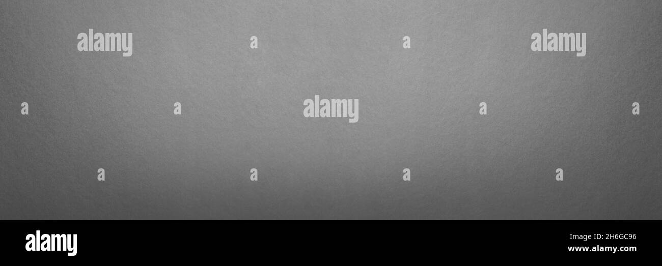Arrière-plan en papier texturé gris.Texture panorama en carton gris sans couture.Photo grand format pour impression ou bannière.Pour votre projet ou conception. Banque D'Images