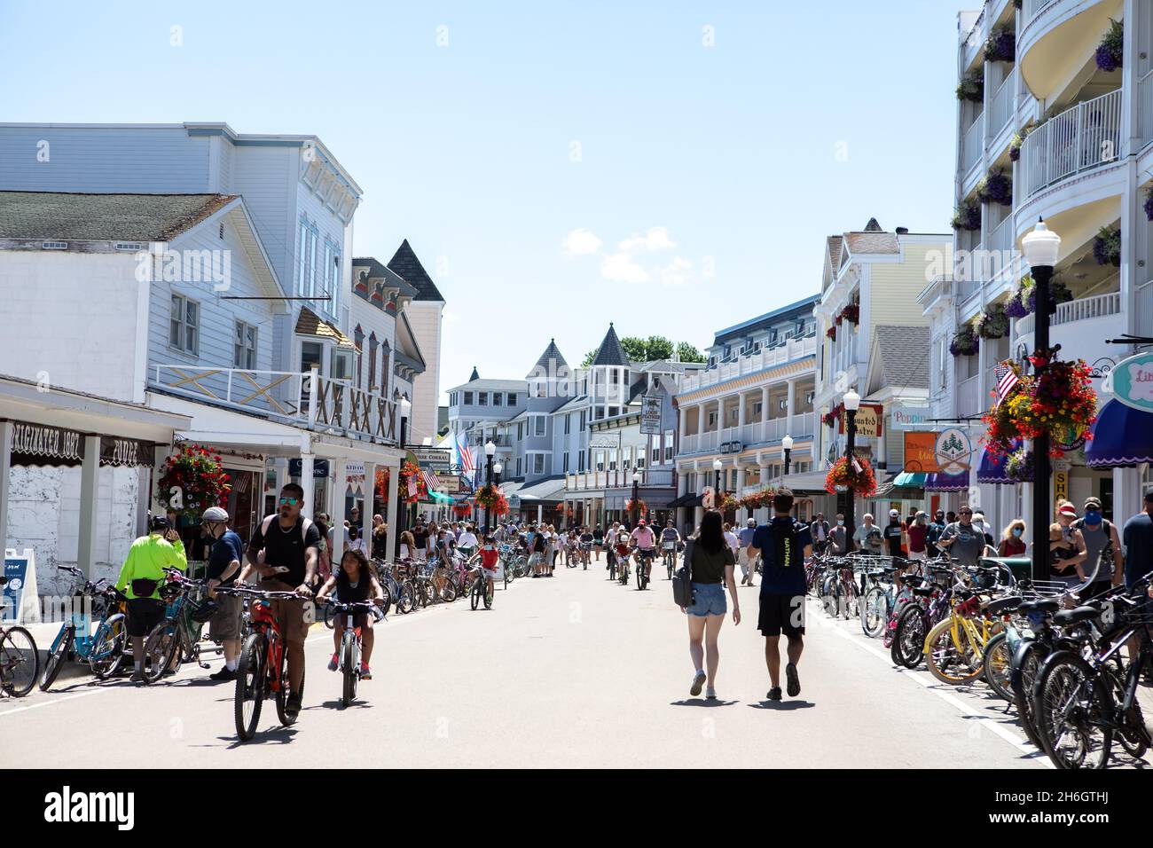 Touristes marchant et à vélo sur la rue principale de l'île Mackinac Banque D'Images