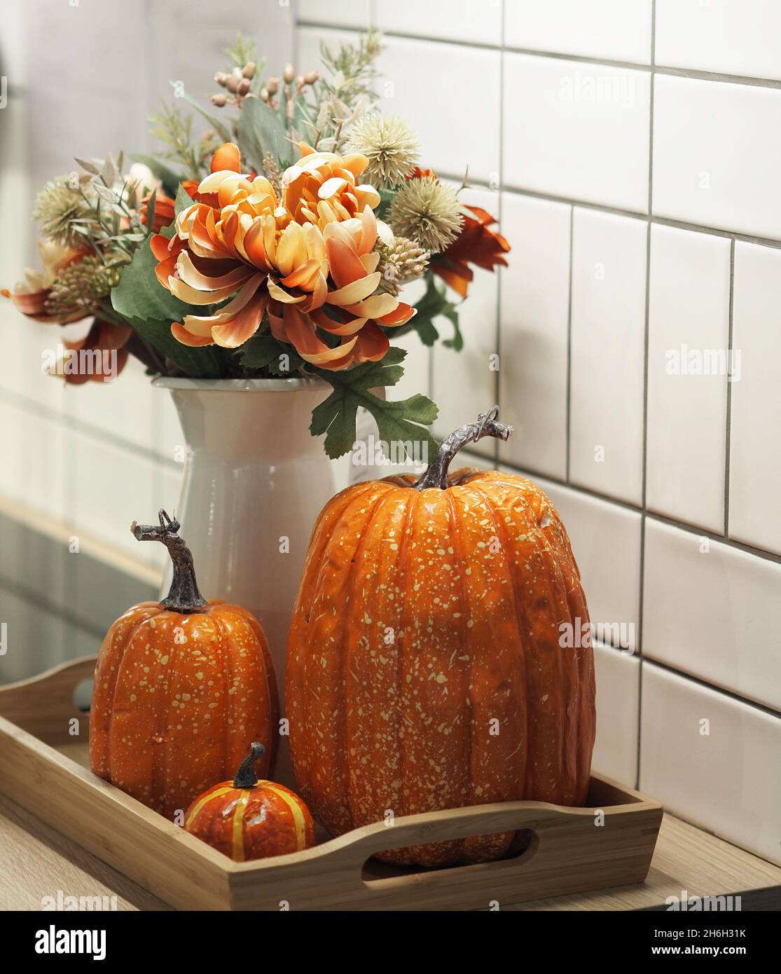 Belle vie de citrouille et de fleurs dans une carafe. Banque D'Images