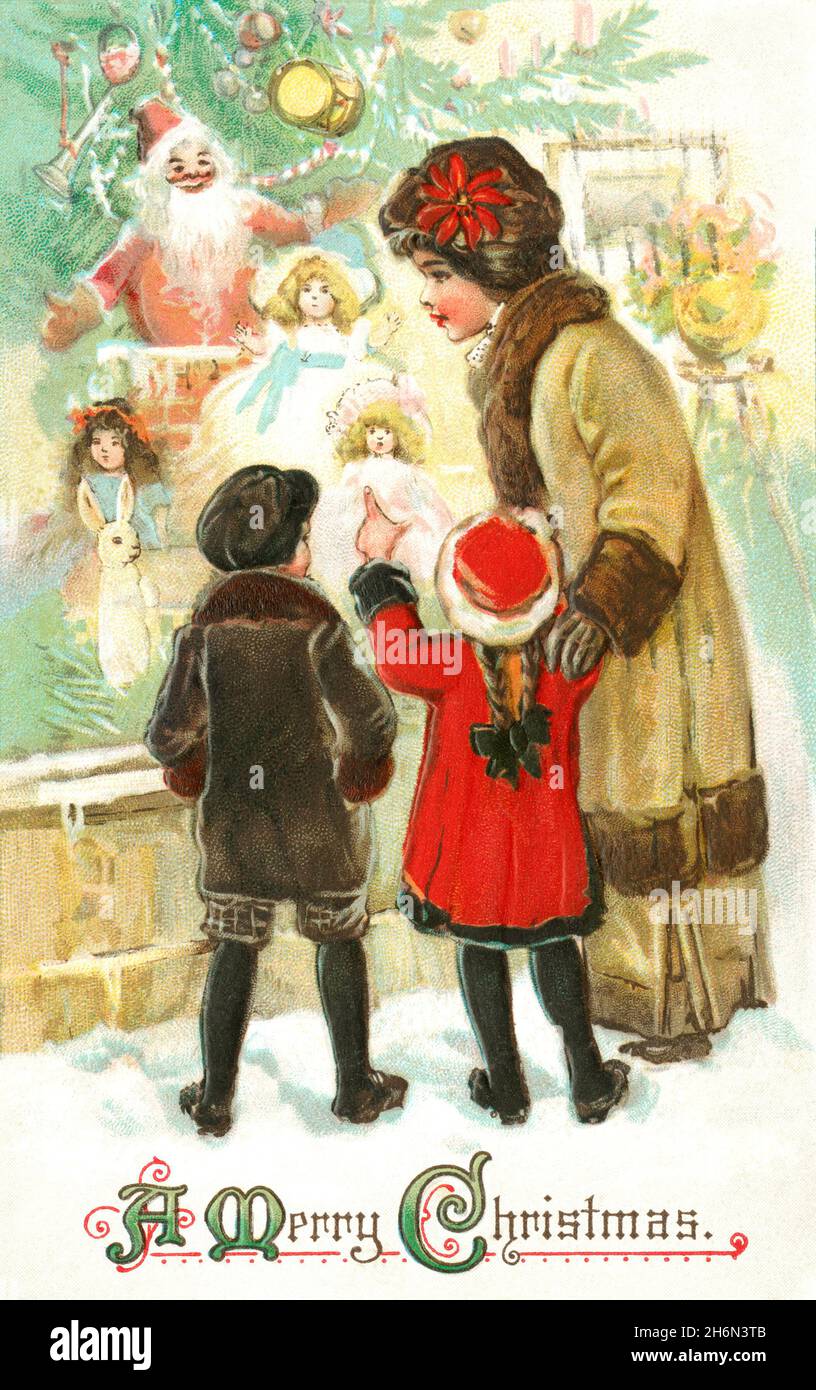 Mère et enfants regardant le Père Noël et les décorations Banque D'Images