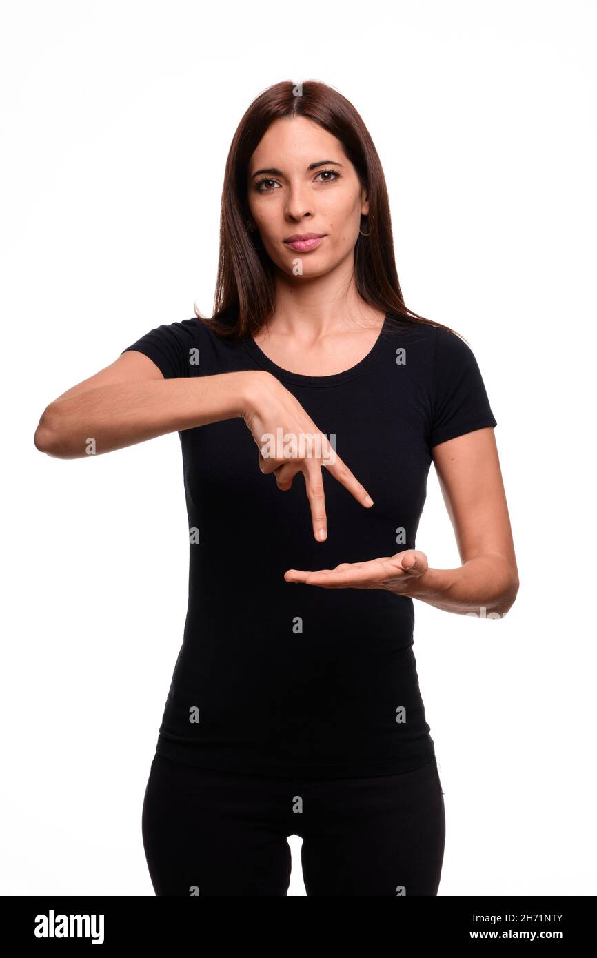Isolé en fond blanc une femme brunette disant la danse en espagnol signe langue Banque D'Images