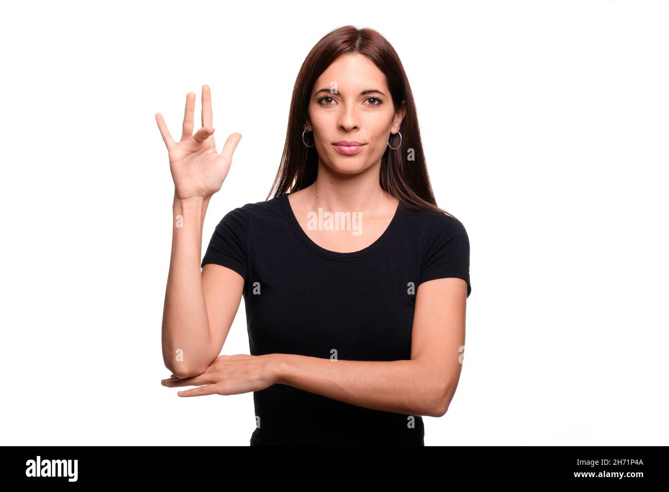 Isolé en fond blanc une femme brunette disant vendredi en langue espagnole des signes Banque D'Images