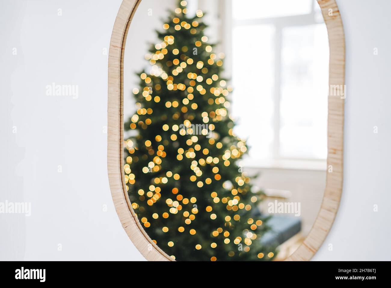 La photo floue de l'arbre de Noël décoré se reflète dans le miroir à la maison Banque D'Images